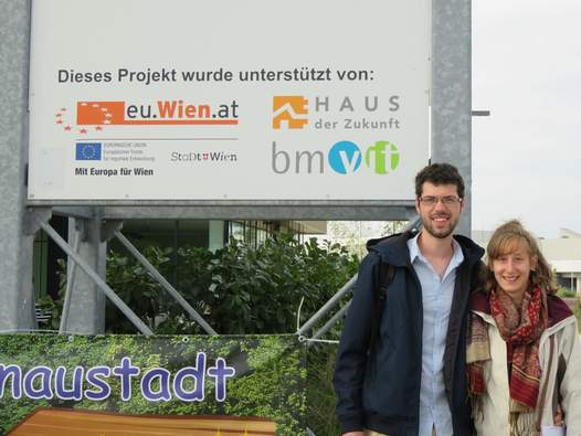 Foto der Gewinner vor dem TZ Aspern IQ, eine Tafel zeigt die Unterstützer des Projektes.