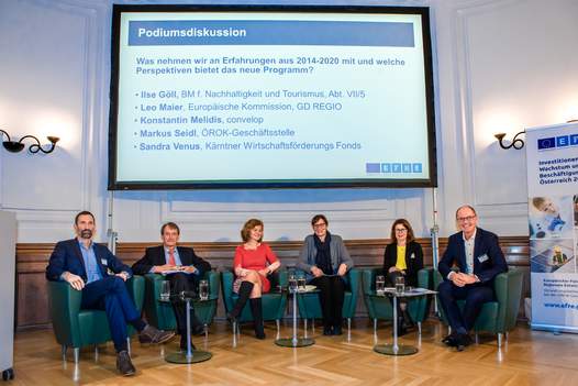 Foto der Podiumsdiskussion mit allen Teilnehmerinnen und Teilnehmern